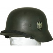 Double decal German army steel helmet M35 with the remains of camouflage